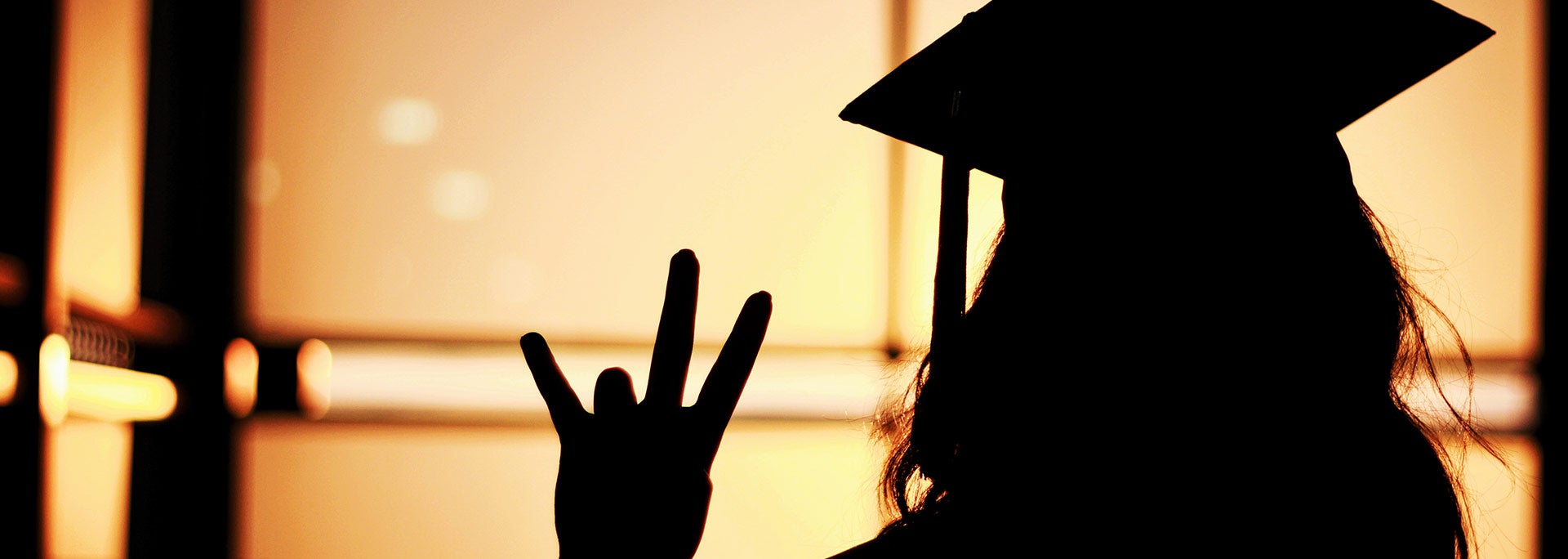 Silhouette of student in graduation cap
