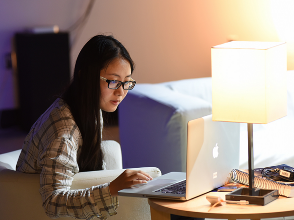 student working in interactive art gallery on computer