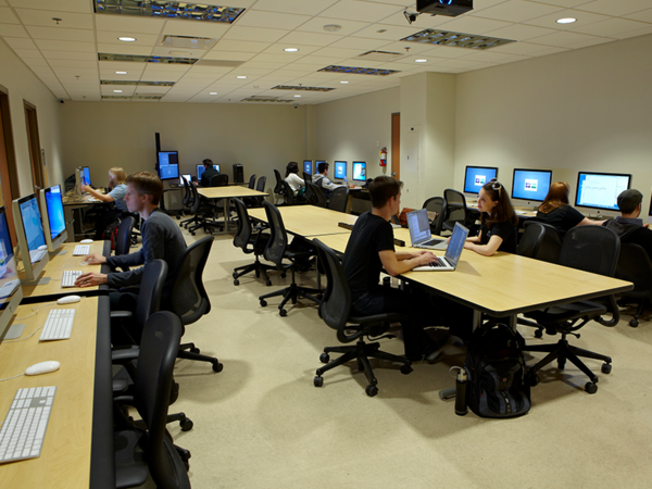 lots of students working in a computer lab on projects