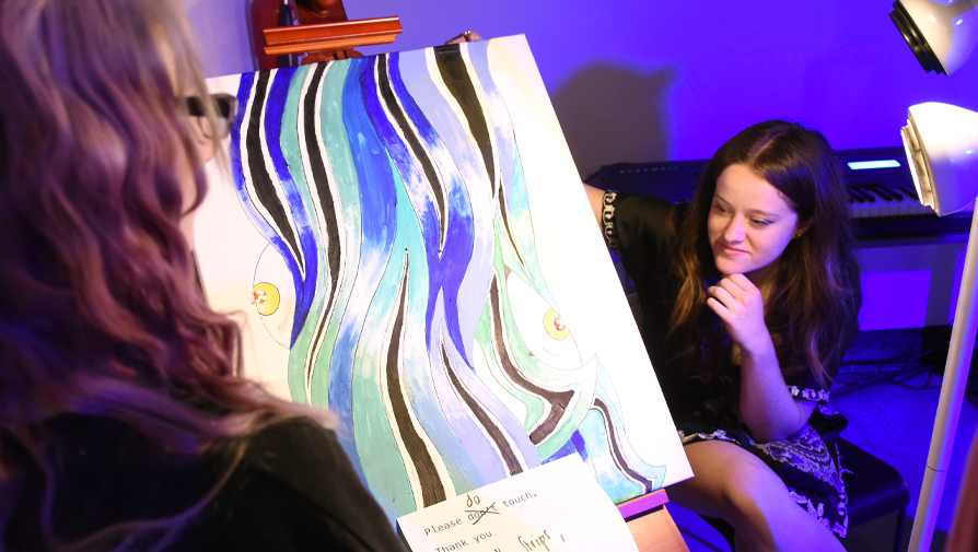 students looking at painting