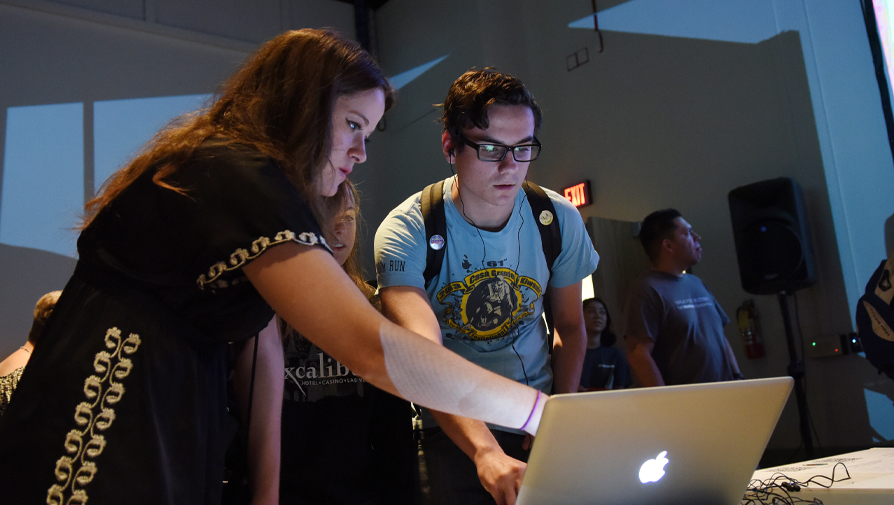 students looking at a laptop