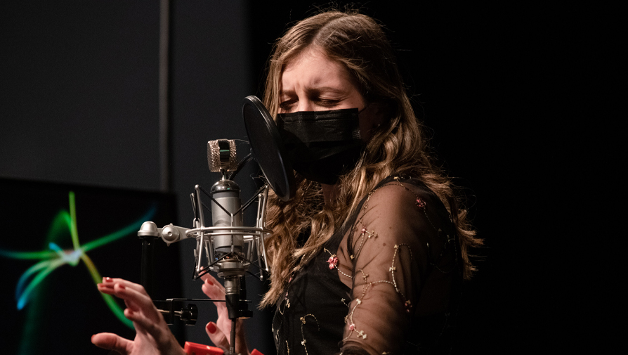 student singing into a microphone