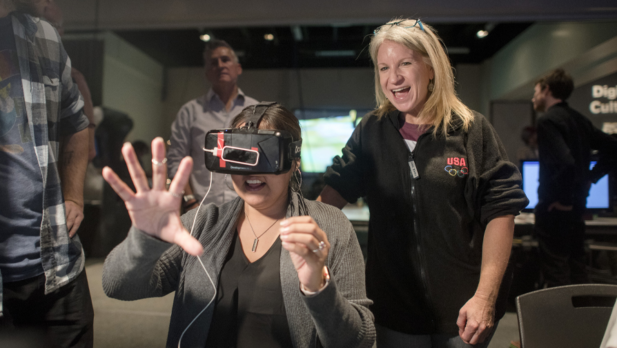 student and faculty testing out a vr headset