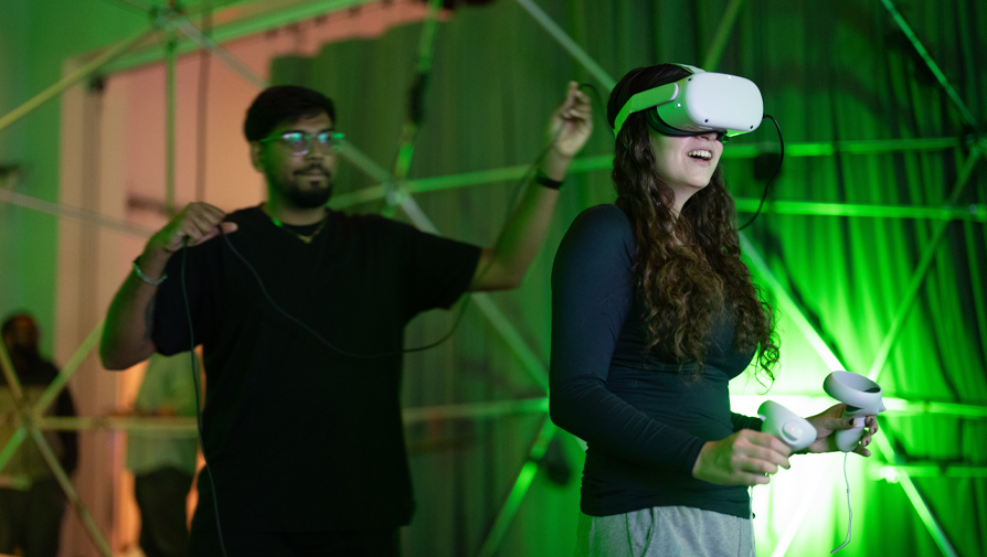 students testing a vr headset and controls