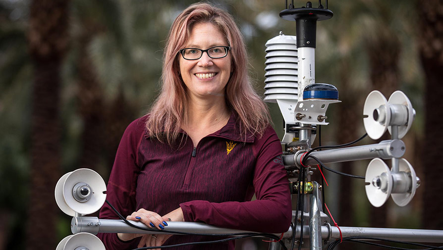 Professor standing next to an engineering project